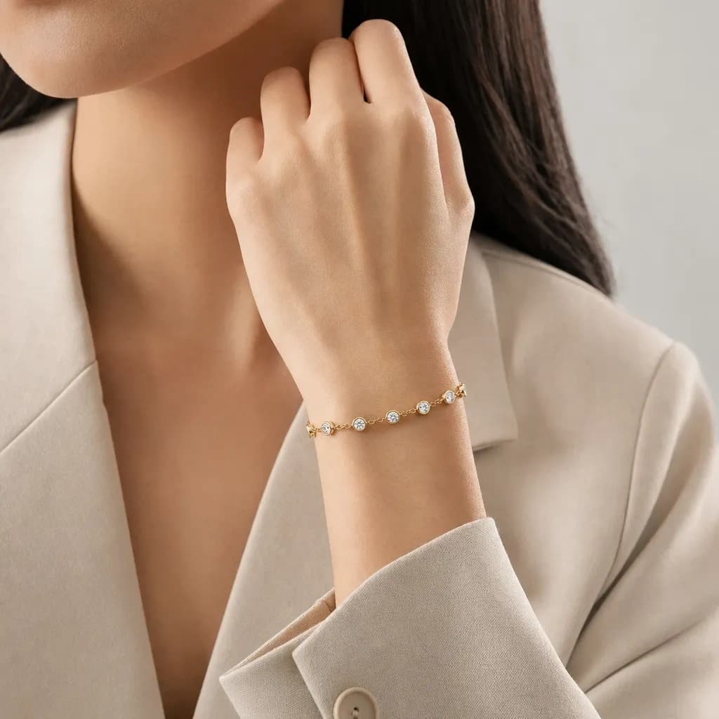 Gold bracelet worn with a white blouse