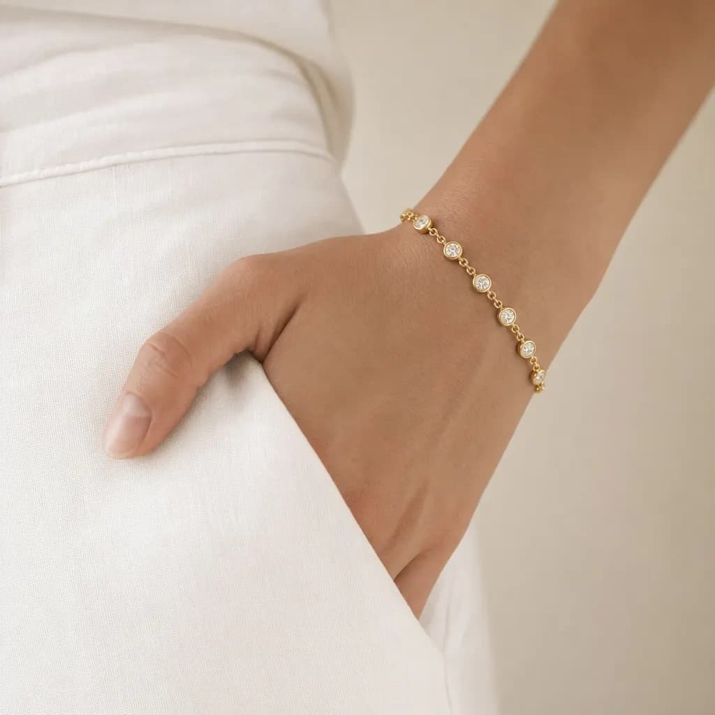 Gold bracelet styled with soft white fabric