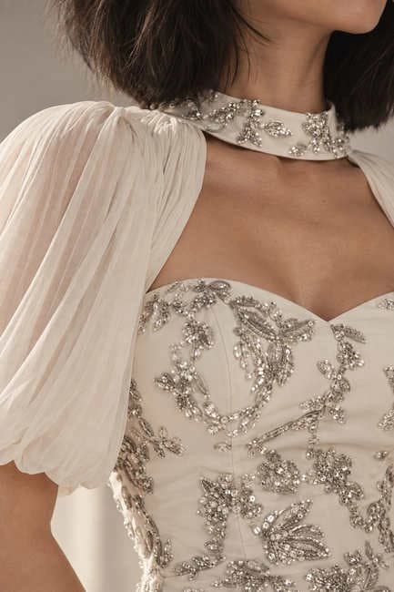 Close-up of the gown's beaded neckline and sheer sleeve